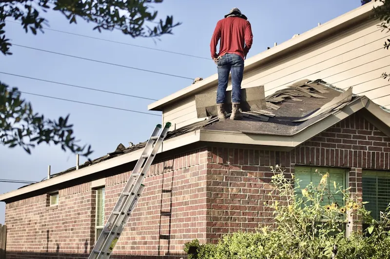 Professional roofer working on a residential roof in Lakebay